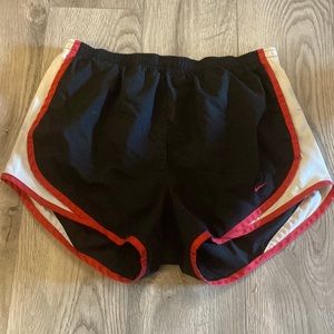 black, red and white Nike shorts, size M